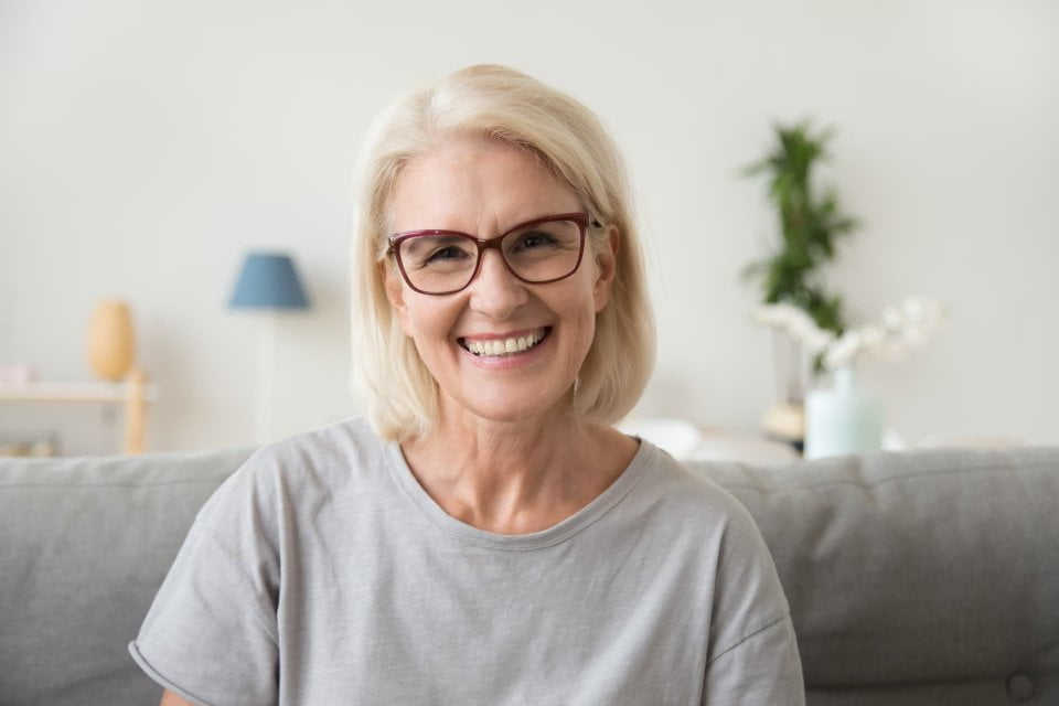 Smiling middle aged mature grey haired woman