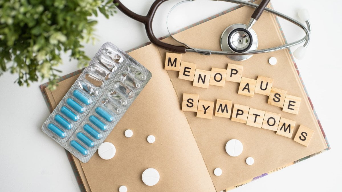 A note book with the words Menopause Symptoms