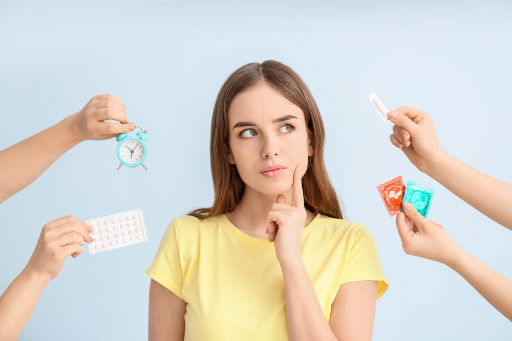 Thoughtful young woman considering different means of contraception
